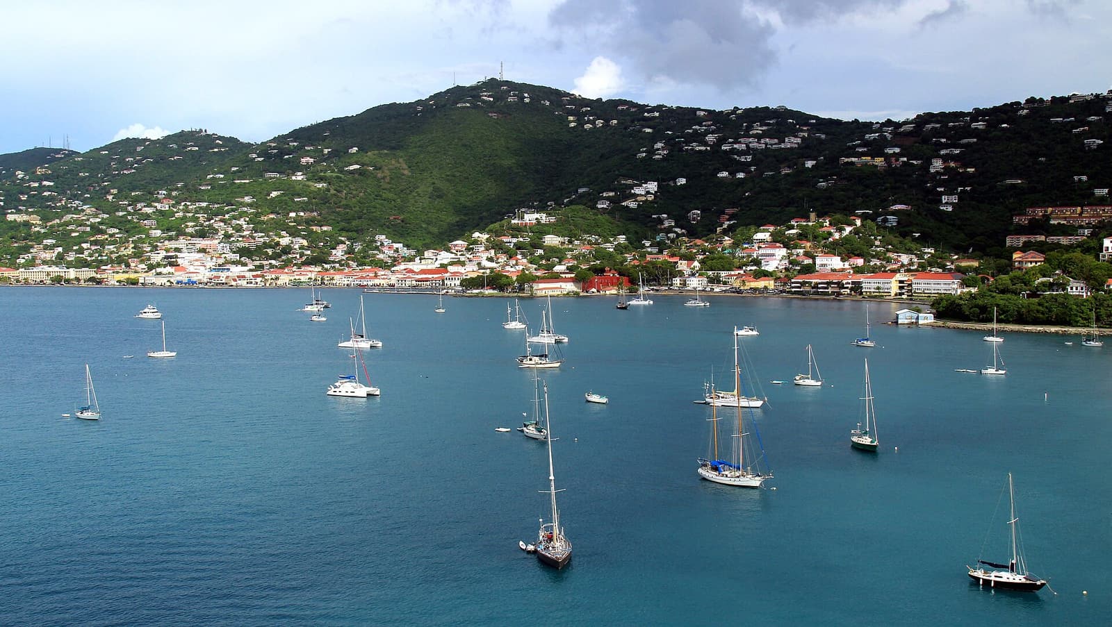 Sailboats anchored in the harbor at Charlotte Amalie, St. Thomas, with the town on the hillside